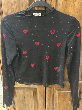 Main Strip Black Sheer Long Sleeve Top with Red Heart Embellishments